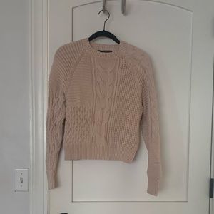 Asymmetrical cable knit sweater